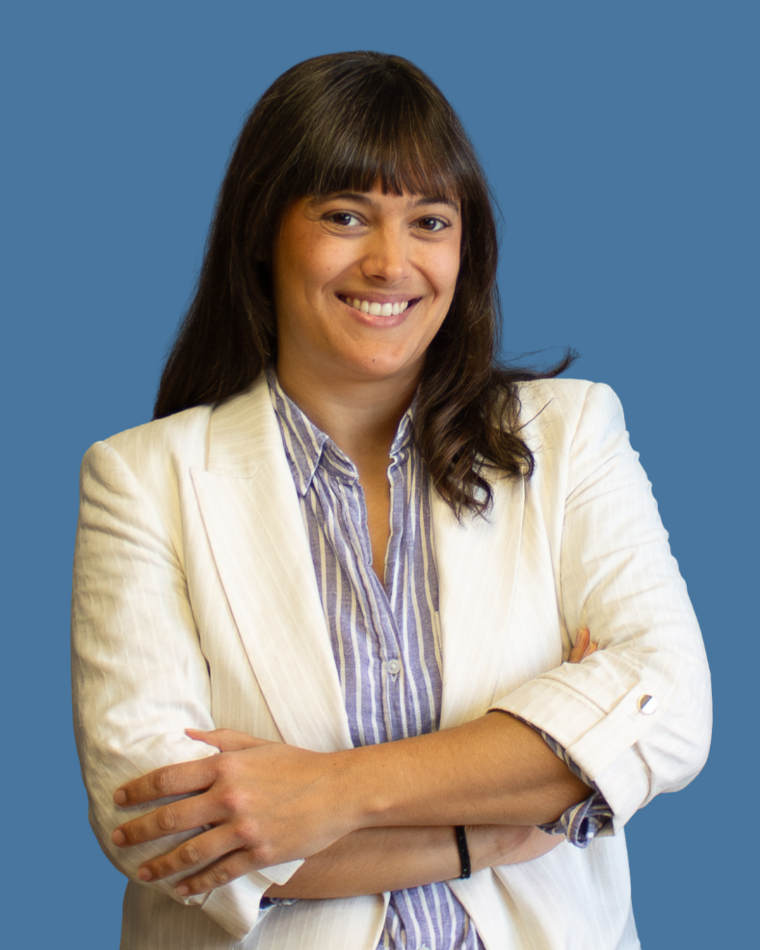 Micaela Lafratta smiling in cream jacket and blue shirt
